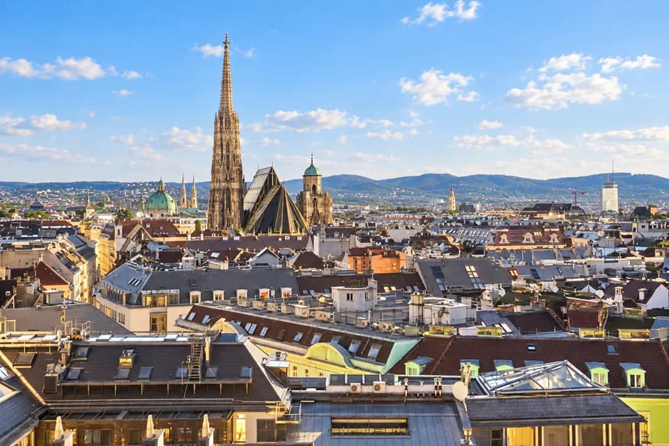 AI-bewerkte sfeerfoto: de Stephansdom torenspits boven de daken van Wenen in zonnig daglicht